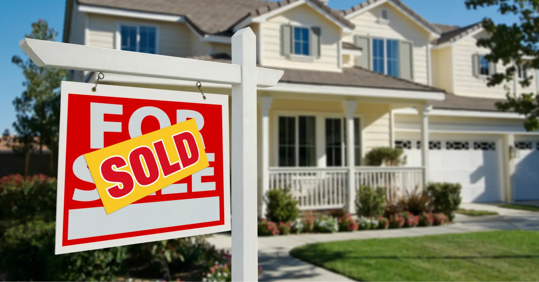 A "For Sale" sign has been changed to say "Sold" in front of a house that was on the market.