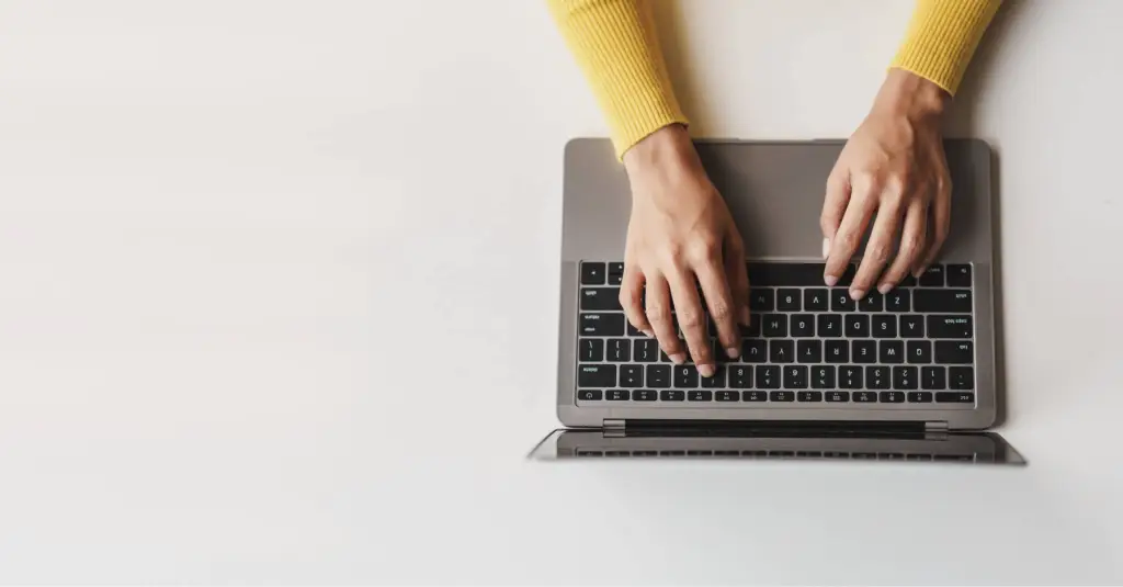 Person typing on laptop representing contractor website design and home services marketing